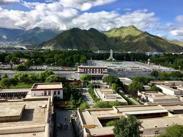 A view over Lhasa from the Potala Palace, with mountains beyond the city.