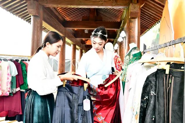 Visitors look at traditional clothing in Qufu, September 2023.