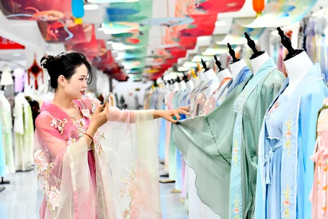 A Hanfu seller presents clothing in a livestream, Caoxian, July 2023.