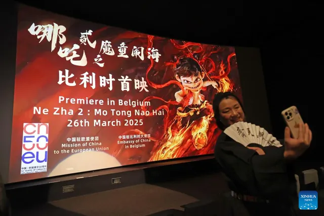 A visitor photographs the Brussels premiere, 26 March 2025.