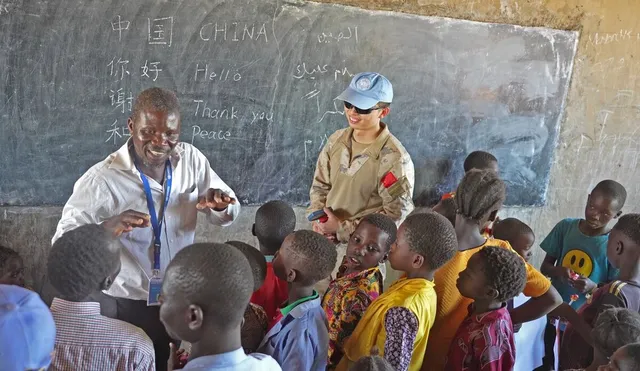 A Chinese peacekeeper joins a classroom activity in the UNMISS community report, October 2024.