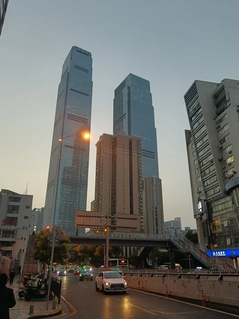 Changsha IFS towers seen from the street at dusk.