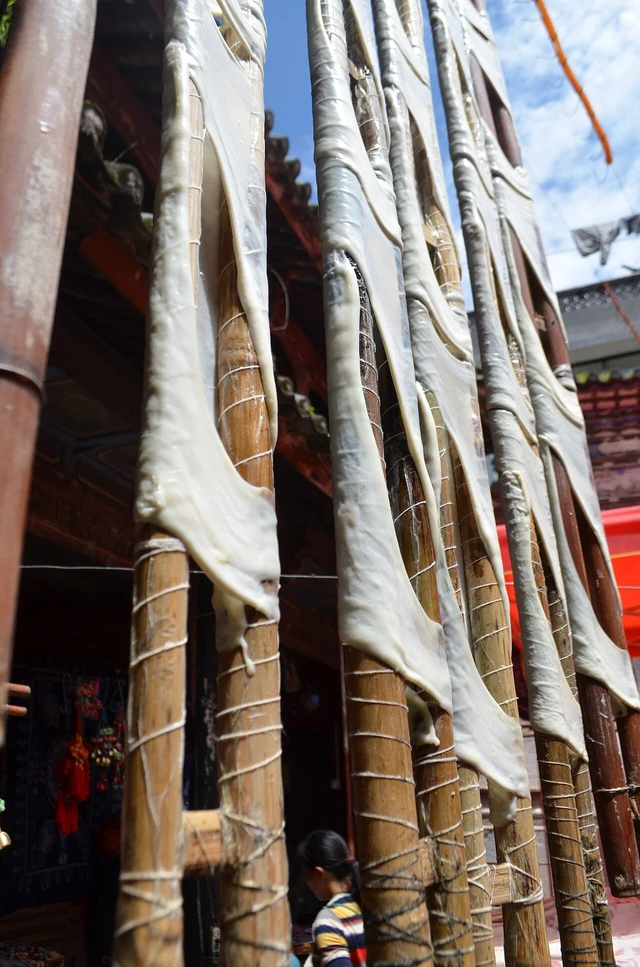 Rushan dairy sheets stretched over rods to dry in Xizhou.