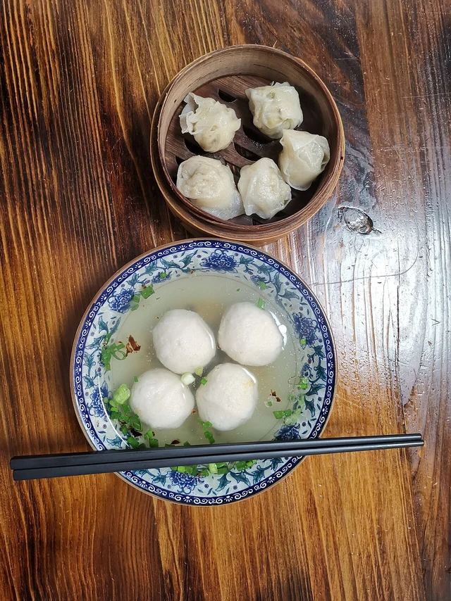 Fuzhou yu wan fish balls in the lower soup bowl, with a separate side dish above.