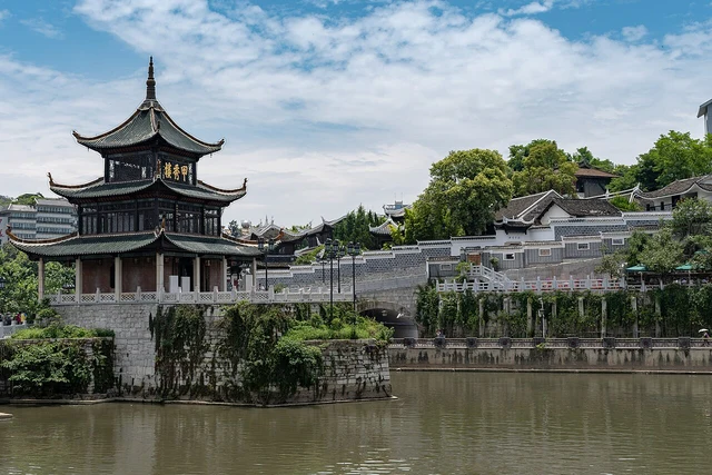 A historical exterior photograph of Jiaxiu Pavilion and the riverside complex in Guiyang.