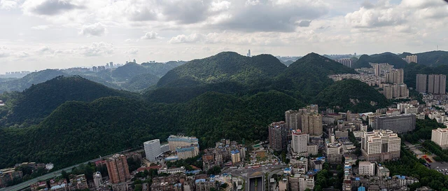 A panorama of woodland and city edges in the Qianling Mountain direction, Guiyang.