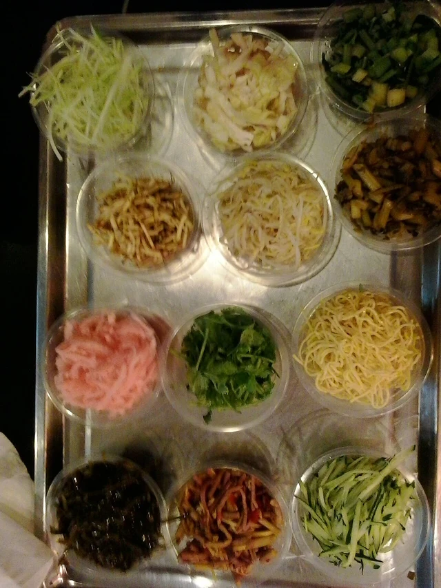 A tray of shredded vegetables and other fillings for siwawa, photographed in Guiyang in 2016; wrappers are outside this frame.