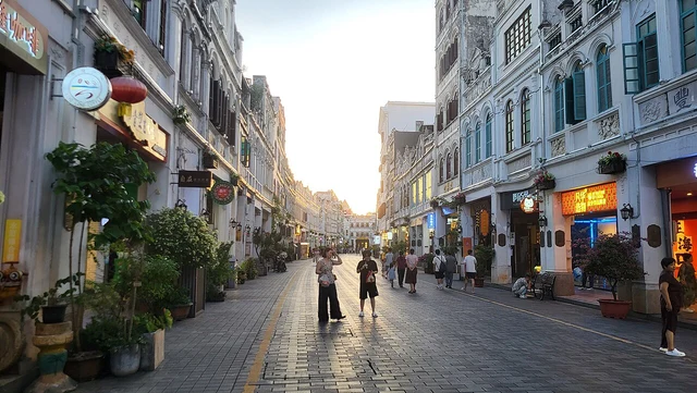 A historical dusk photograph of Zhongshan Road in Haikou’s old arcaded quarter.
