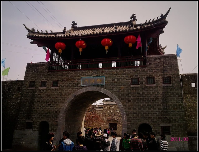 A Sanhe town gate photographed in March 2011, with a Chaoyang Gate plaque visible; not a current-access guarantee.