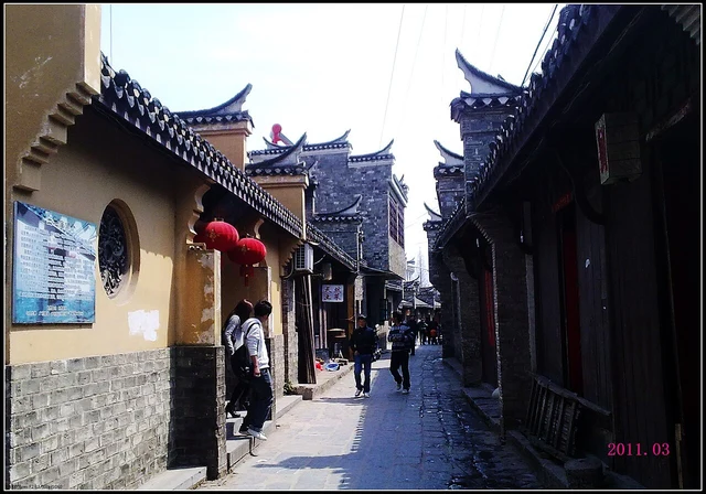 A lane in Sanhe Ancient Town photographed in March 2011; not every frontage is claimed as an unchanged historic building.