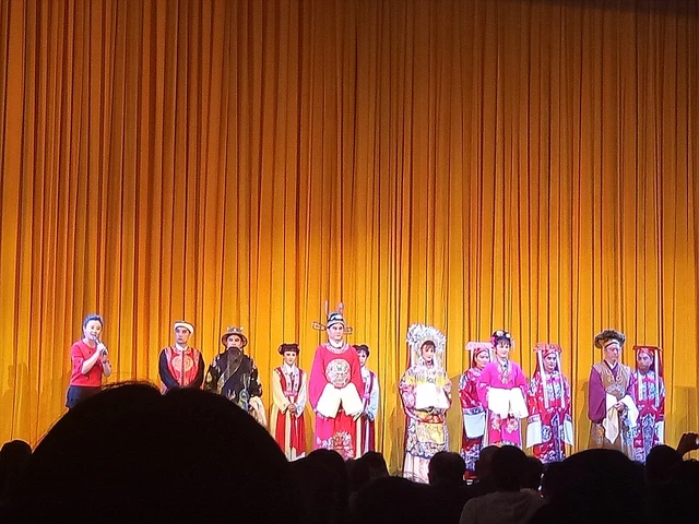 Performers at a curtain call in a photograph identified by its source as Lü opera; the source does not name the play, theatre, capture date or city.