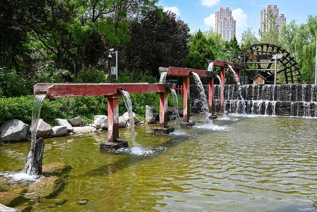 Water-lifting devices and landscaping inside Lanzhou Waterwheel Expo Park.