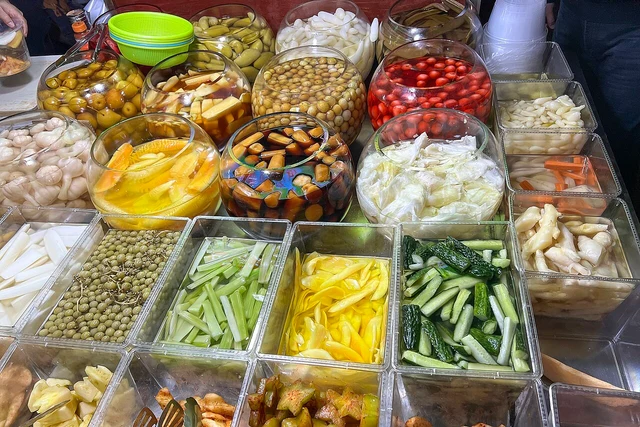 Pickled fruit and vegetables at a Three Streets and Two Lanes stall in Nanning, February 2024.