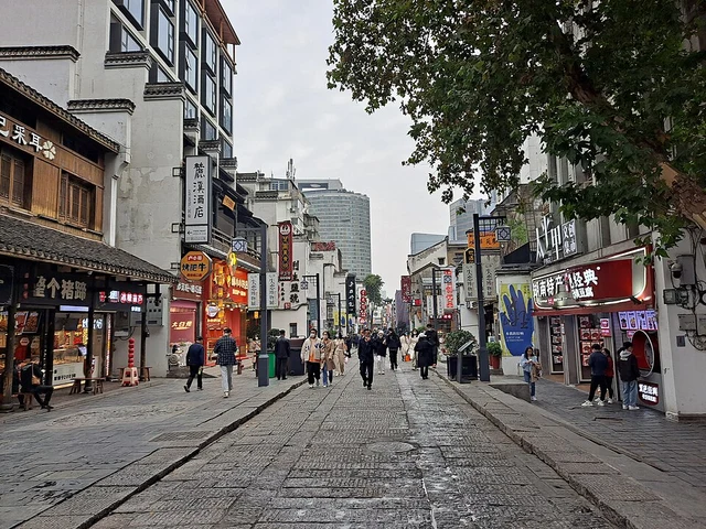 Stone-paved Taiping Old Street with shops and pedestrians in Changsha.