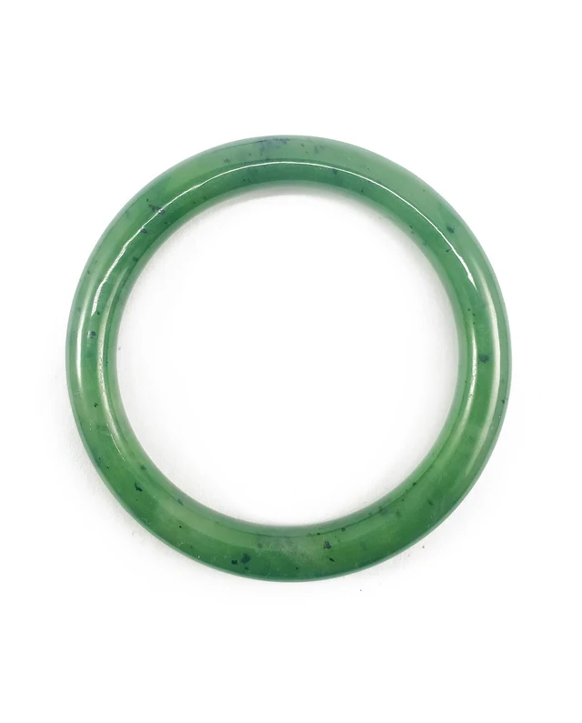 A green nephrite jade bangle photographed against a white background.