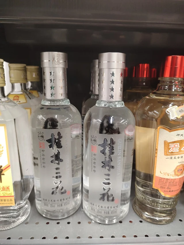 Bottles of Guilin Sanhua rice wine on a shelf in Shenzhen in July 2026.