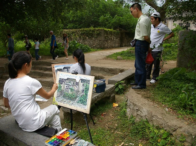 Painters working outdoors in Xingping town in May 2009.