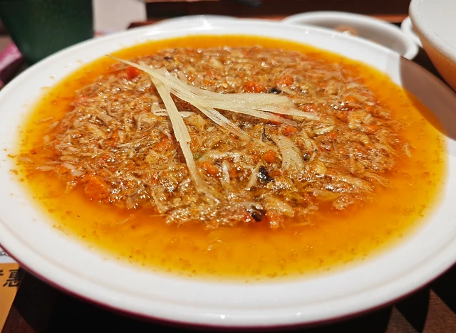 Crab-roe topping served as part of a Suzhou crab-roe noodle dish.