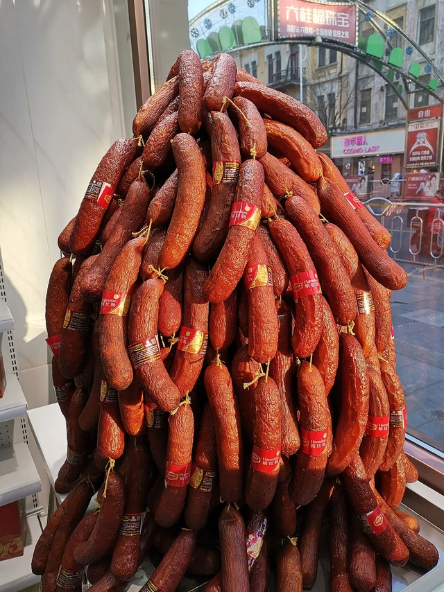 Harbin red sausages with labels, hanging together in a shop display.
