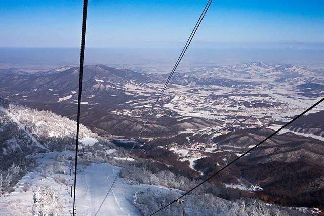 A view from a chairlift above snowy slopes at Yabuli Ski Resort.