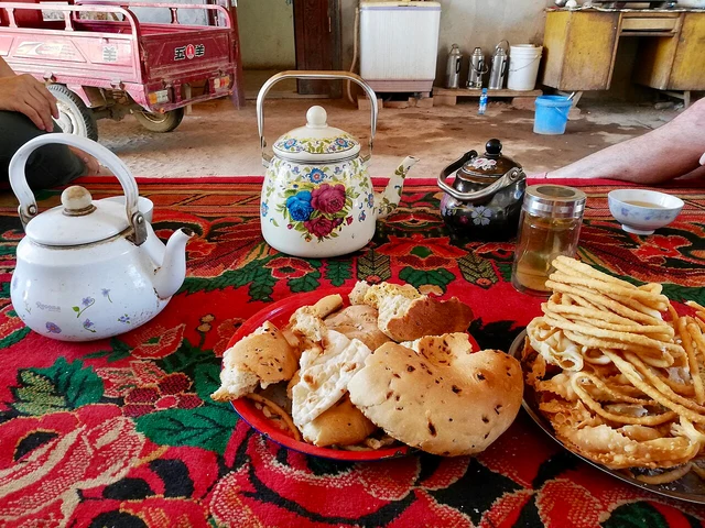 Naan, sangza and tea served in a Uyghur household courtyard near Turpan in August 2018.