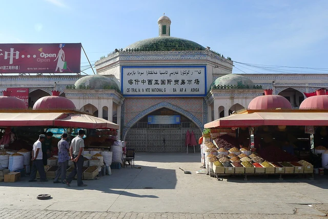 The entrance and street vendors of the Central Asia International Grand Bazaar in Kashgar.
