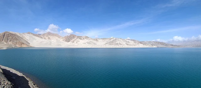 Blue water and pale sand hills at Bulungkol Reservoir, known as Baisha Lake, in April 2015.