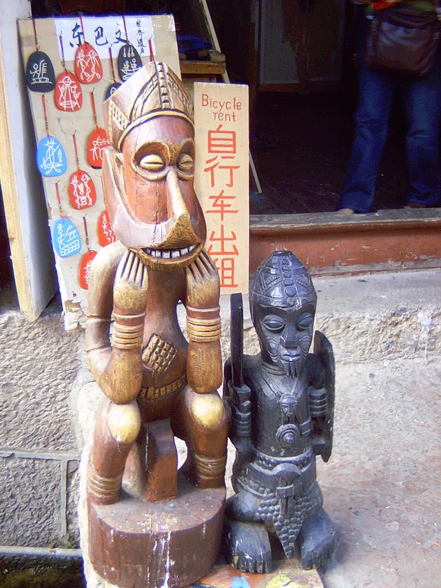 Two Dongba wood carvings outside a shop in Shuhe, Lijiang, in October 2009.