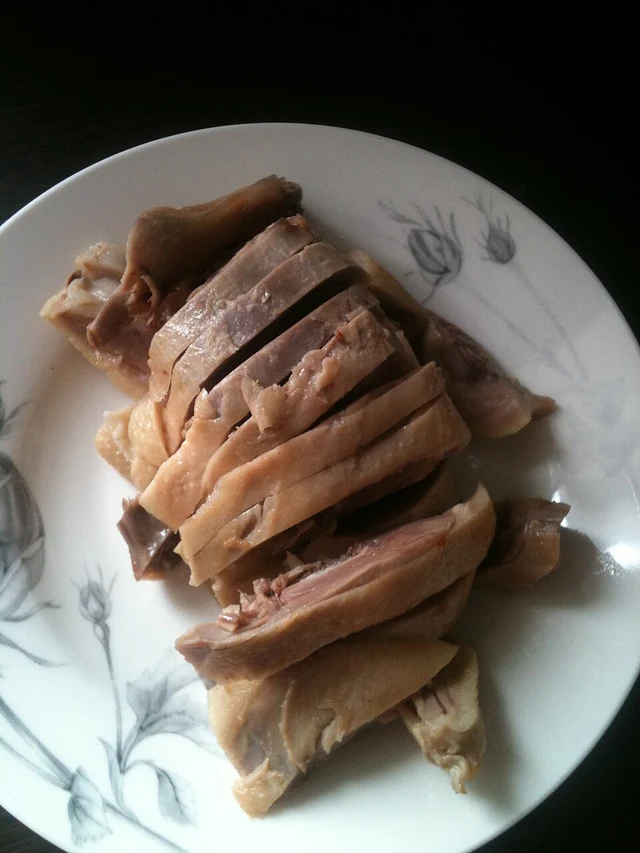 Slices of Nanjing salted duck on a white plate.
