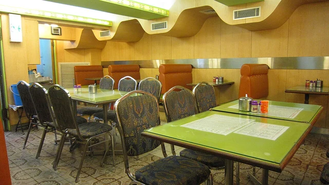 Tables, chairs and booths inside a cha chaan teng in Mongkok, Hong Kong.