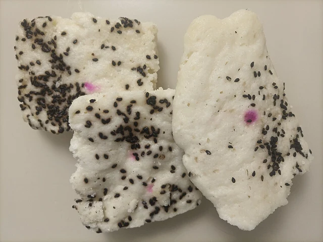 Pieces of Suzhou-style rice cake with sesame on a plate.