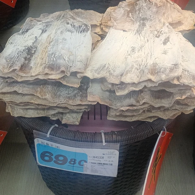 Dried squid displayed above a Hong Kong dollar price sign.