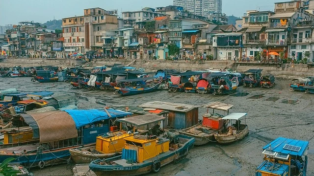 Covered fishing boats beside waterfront houses at Shapowei, Xiamen.
