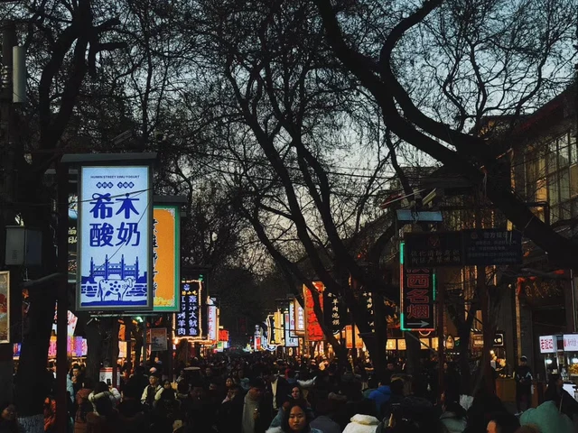 Shops, crowds and a yoghurt sign at the south entrance of Xi'an's Muslim Street.