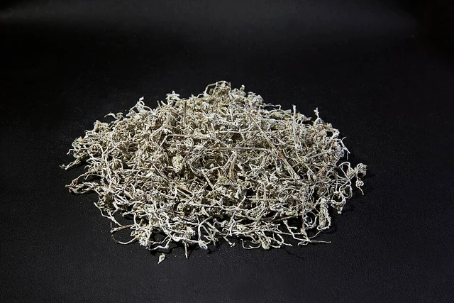 A pile of dried vine-tea leaves and stems, photographed as a Moyeam product.