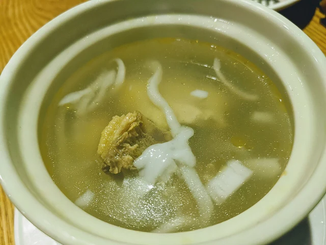A single serving of Hainanese coconut chicken soup at Yeh Ting in Woodlands, Singapore; an overseas dish example.