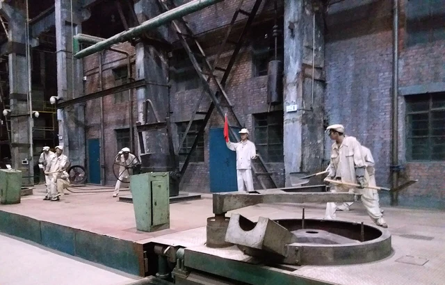 A historical foundry-work display with figures and equipment inside the Industrial Museum of China in Shenyang; not active production or a guarantee of today’s gallery layout.