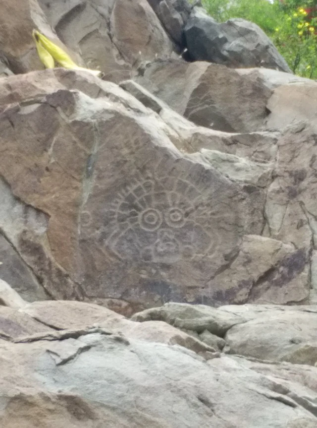 A face motif photographed at the Helan rock-art site; verify in-situ or reproduction status, dating and interpretation rather than deriving height from the photograph.