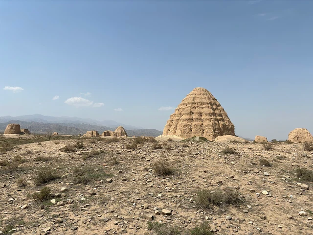 A photograph at the Xixia tomb site; identify the specific tomb and current access from labels and notices.