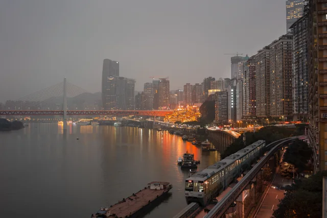 Illuminated buildings by the river in Chongqing.