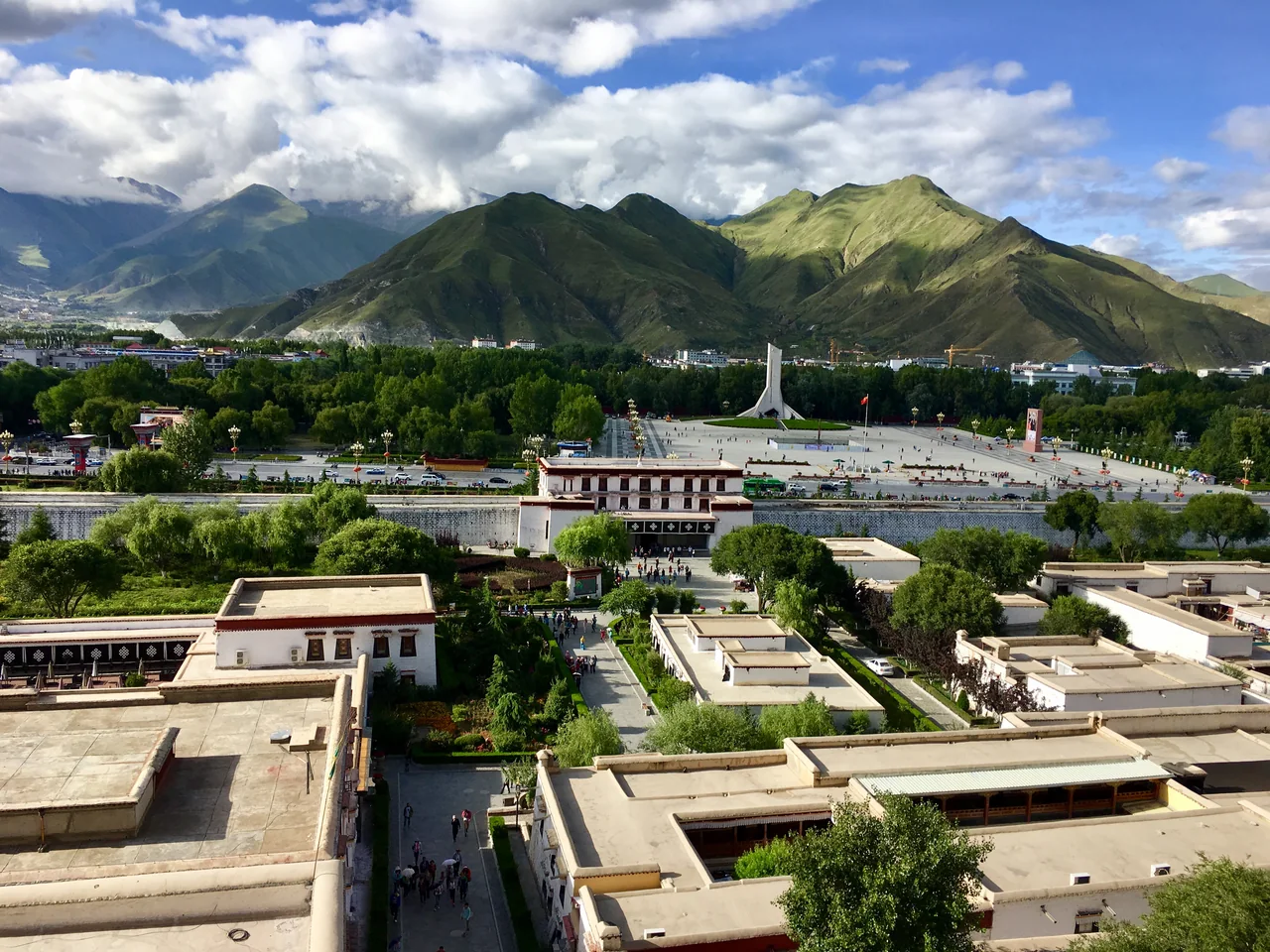 A view over Lhasa from the Potala Palace, with mountains beyond the city.