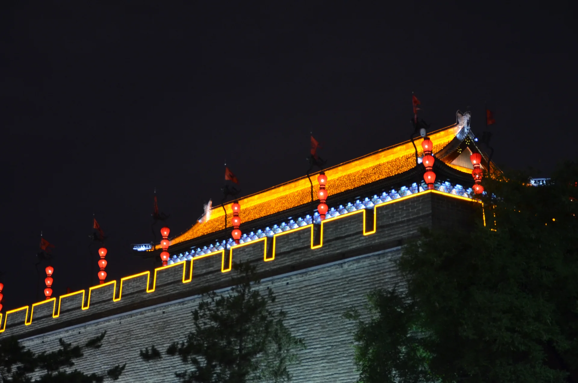 A watchtower and city wall illuminated at night in Xi’an.