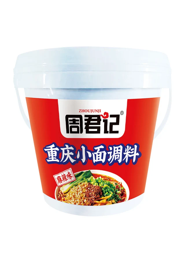 A white pail of Zhoujunji Chongqing Xiaomian Seasoning with its original red product label.