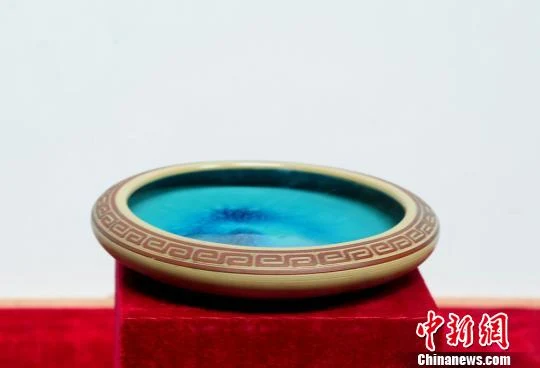 A shallow Rongchang pottery vessel with a turquoise-glazed interior and patterned rim.