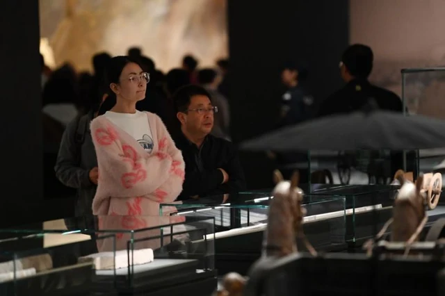 Visitors view bamboo and wooden slips in Gansu Jiandu Museum, Lanzhou, on 25 October 2023; photograph by Chen Bin/Xinhua.
