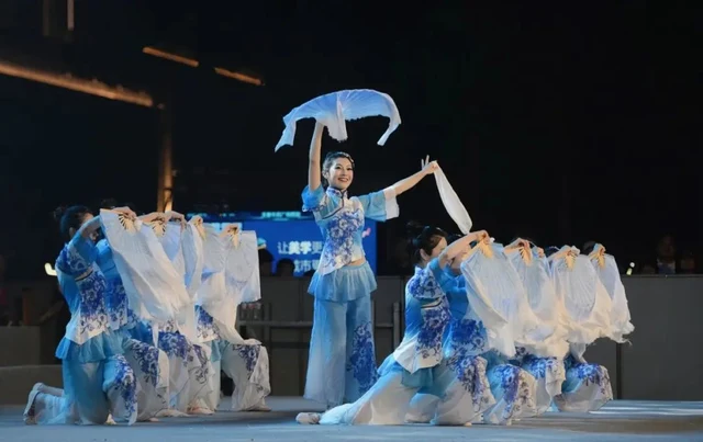 Jiaozhou yangge dancers perform Spring Outing during their 2023 Kyrgyzstan tour, as identified by Guangming Daily.