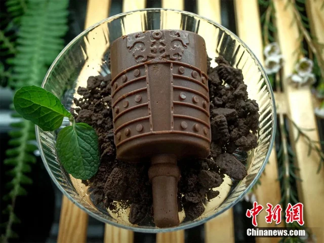 A chocolate cake shaped like a decorated bronze bell at Hubei Provincial Museum.