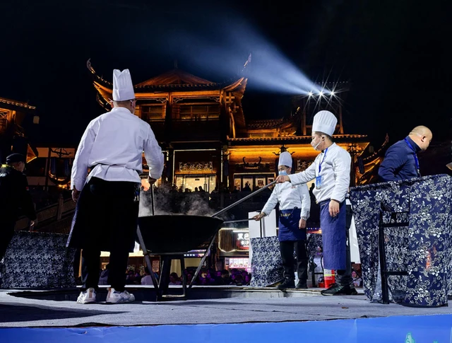 Chefs preparing Zhangjiajie sanxiaguo at the local food festival.
