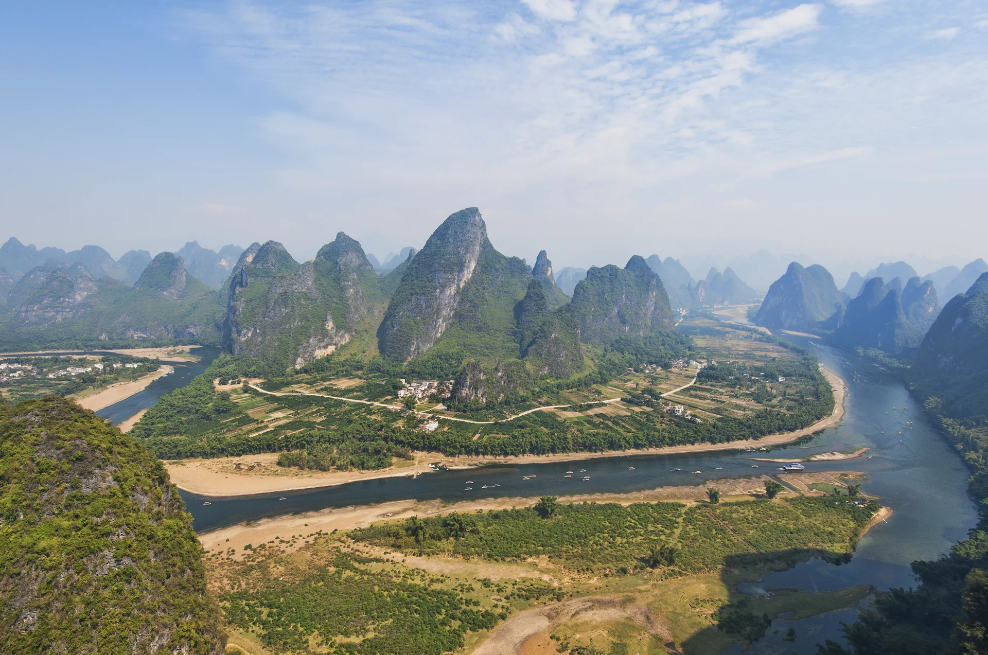 The Li River winding between green limestone peaks near Yangshuo, Guangxi.